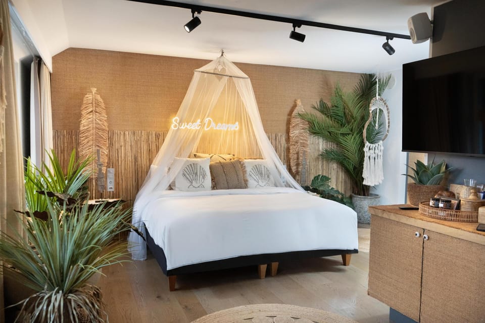 Suite (Experience) | Minibar, in-room safe, laptop workspace, blackout drapes
