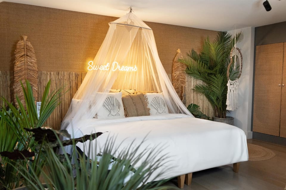 Suite (Experience) | Minibar, in-room safe, laptop workspace, blackout drapes