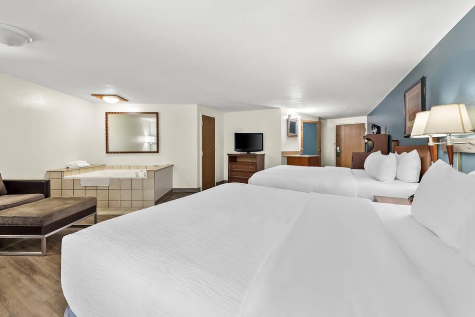 Standard Room, 2 Queen Beds, Non Smoking, Jetted Tub | In-room safe, laptop workspace, blackout drapes, iron/ironing board