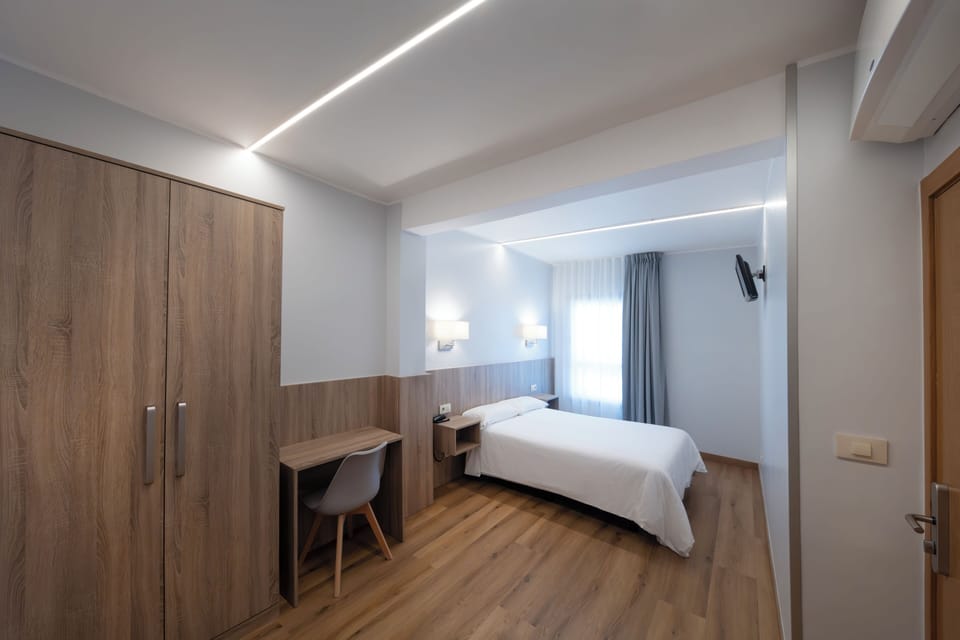 Economy Double Room | Desk, laptop workspace, blackout drapes, iron/ironing board