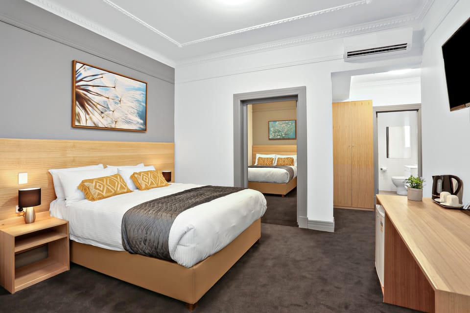 Deluxe Quadruple Room, 2 Queen Beds, Non Smoking | In-room safe, desk, free WiFi, bed sheets