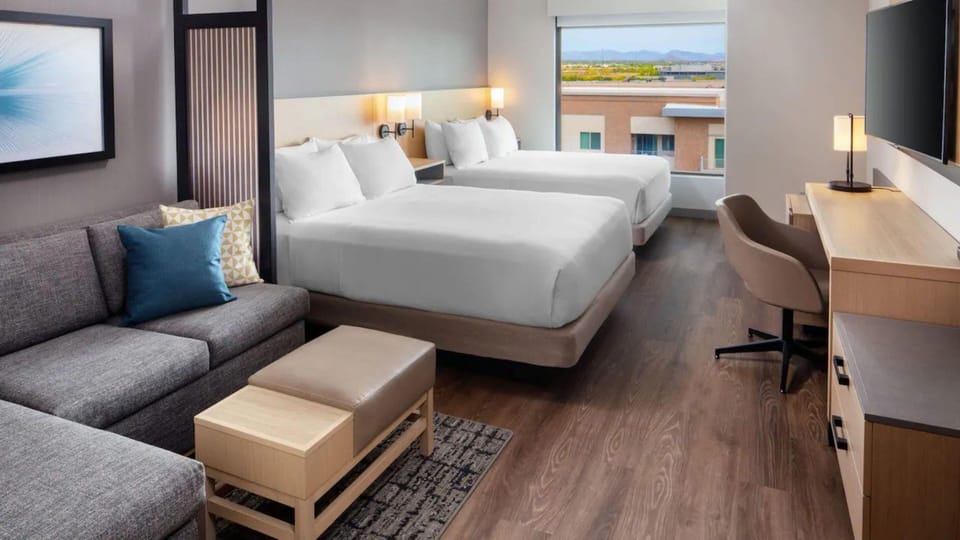 Hypo-allergenic bedding, desk, laptop workspace, blackout drapes