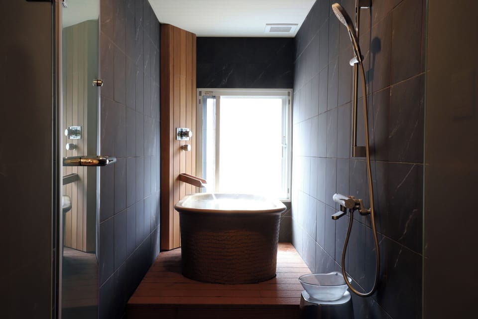 [Roshokan Japanese western style room] Twin bed with Futon & Hot spring bath | Bathroom | Slippers, electronic bidet, towels