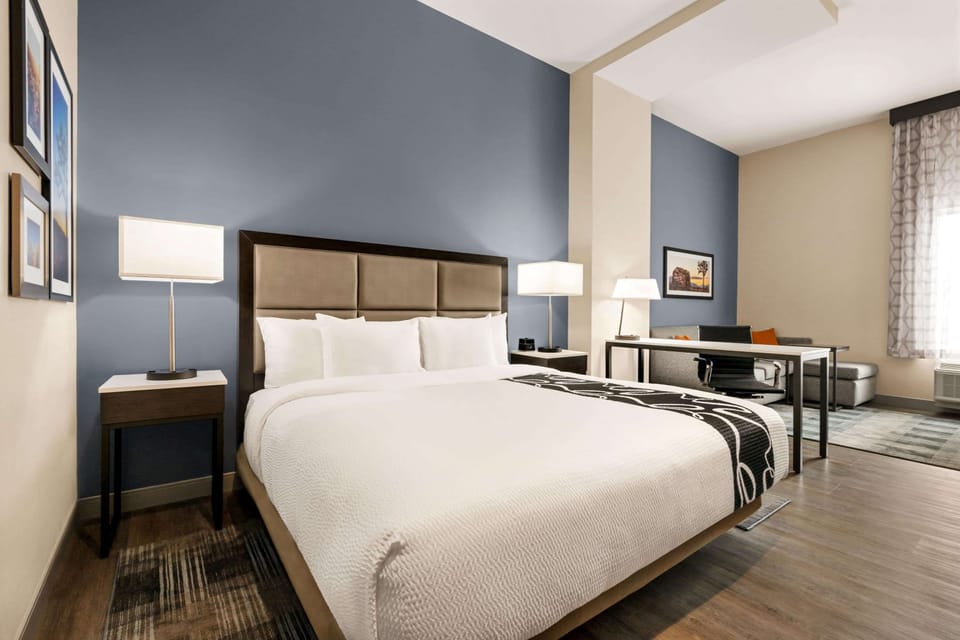 Suite, 1 King Bed, Non Smoking | Desk, laptop workspace, blackout drapes, iron/ironing board