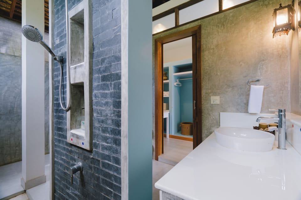 Family Villa | Bathroom | Separate tub and shower, rainfall showerhead, hair dryer, slippers