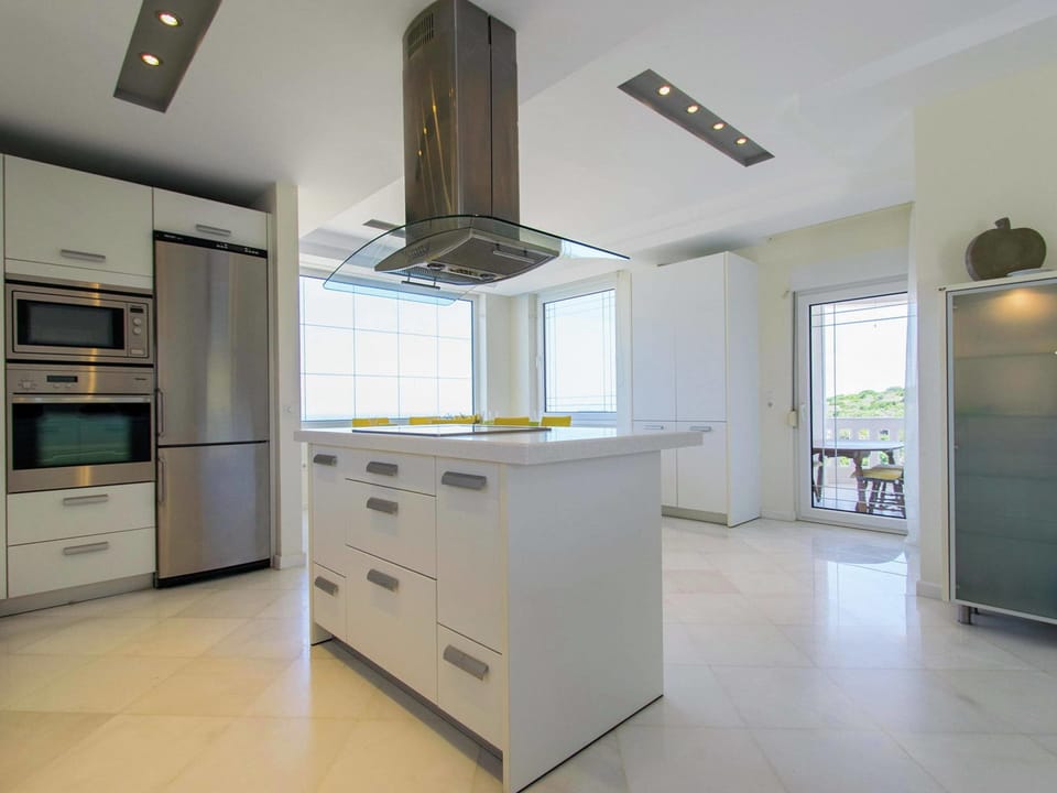 Villa | Private kitchen | Stovetop, electric kettle, toaster, highchair
