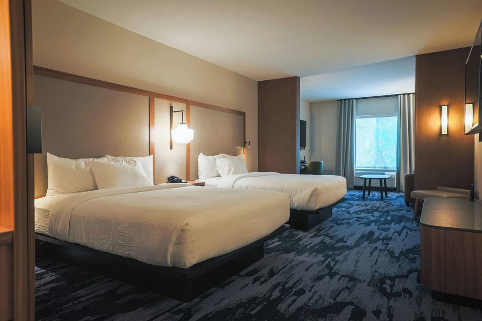 Suite, Multiple Beds, Partial Lake View | Desk, laptop workspace, blackout drapes, iron/ironing board