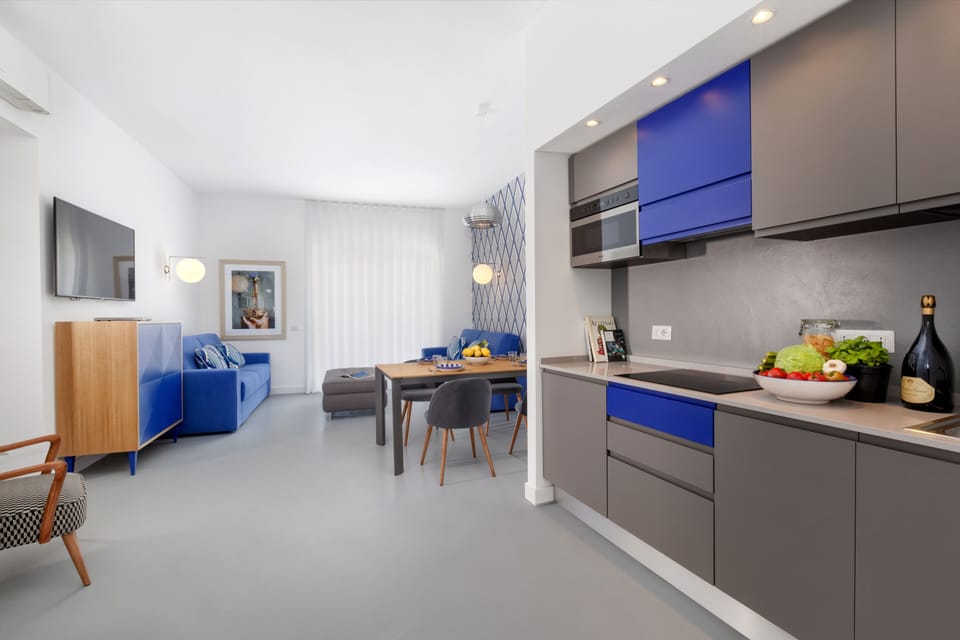 Design Apartment | Private kitchen | Microwave, spices, cleaning supplies, dining tables