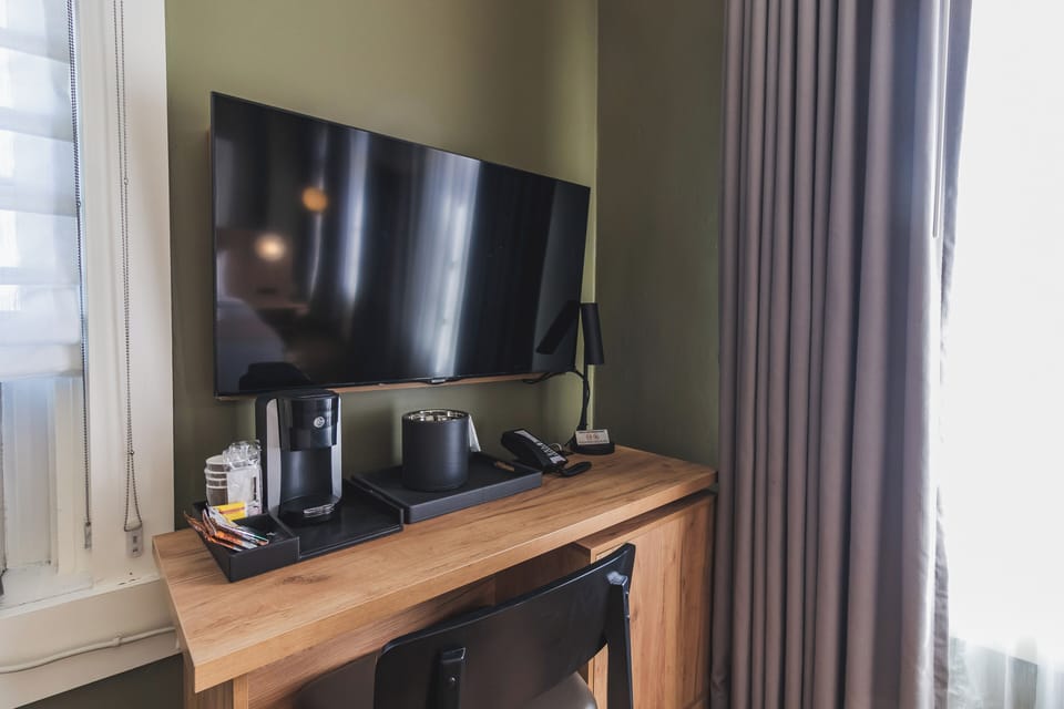 Suite, 1 King Bed, City View | Living area | 32-inch TV with cable channels