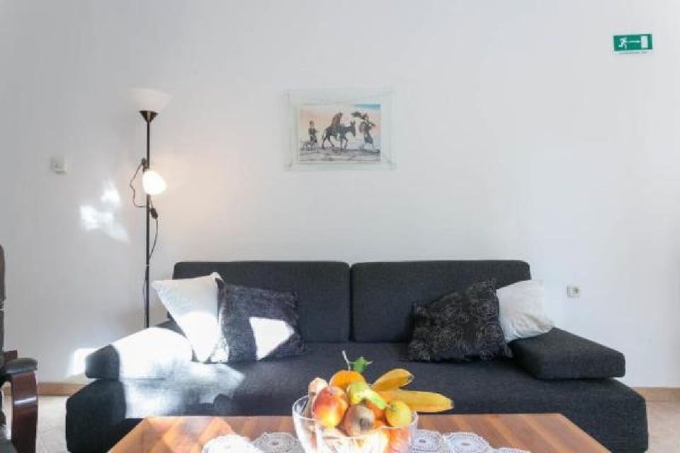 Apartment (One-Bedroom Apartment with Balcony) | Living room | 25-inch flat-screen TV with cable channels, TV