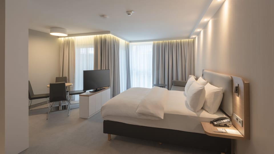 Suite, 1 Queen Bed, Balcony | In-room safe, laptop workspace, blackout drapes, soundproofing