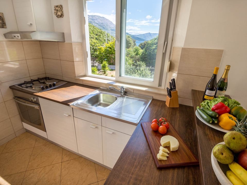 Apartment (Two-Bedroom Apartment with Sea View) | Private kitchen | Fridge