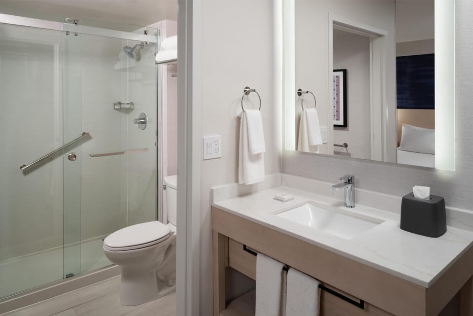 Combined shower/tub, designer toiletries, hair dryer, towels