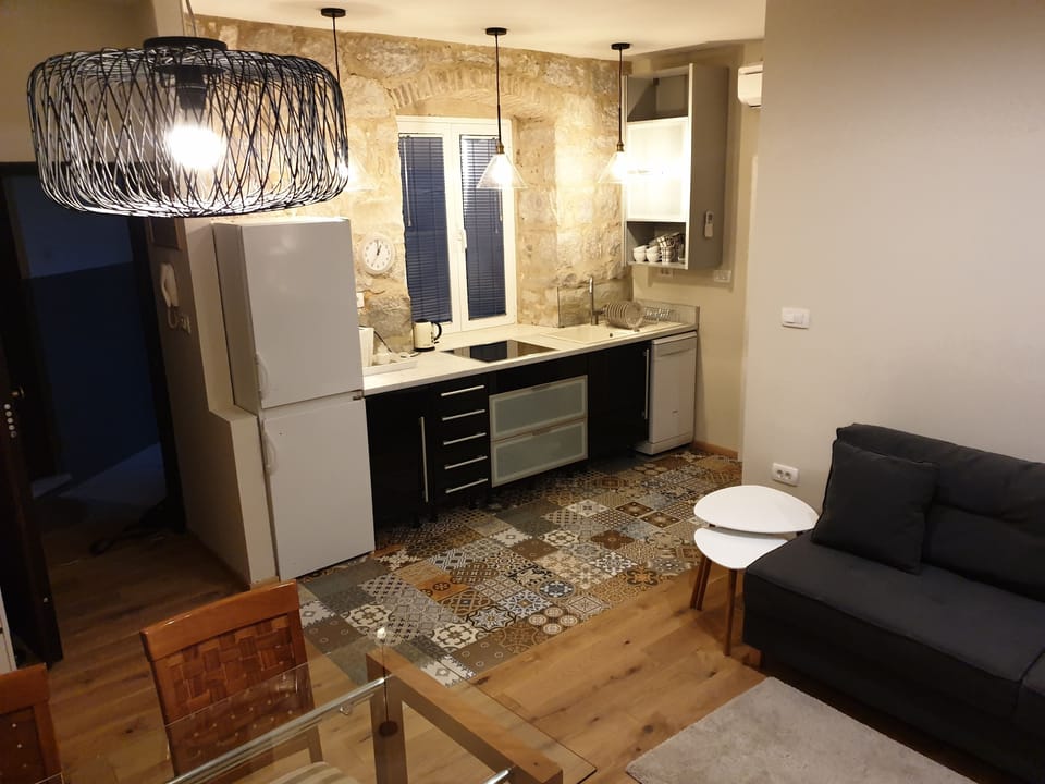 One Bedroom Apartment with Balcony | Living area | 125-cm LCD TV with cable channels, TV