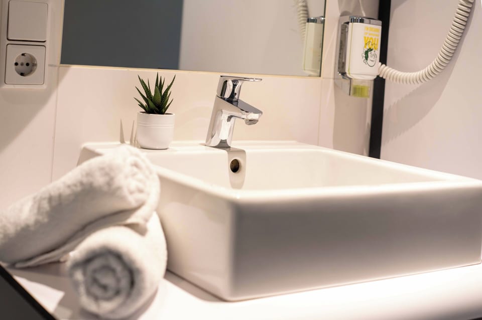 Shower, rainfall showerhead, hair dryer, towels
