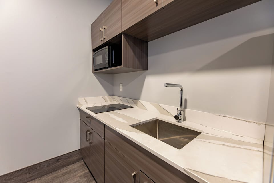 Family Kitchenette Suite | Private kitchen | Coffee/tea maker, mini-fridge, microwave, freezer