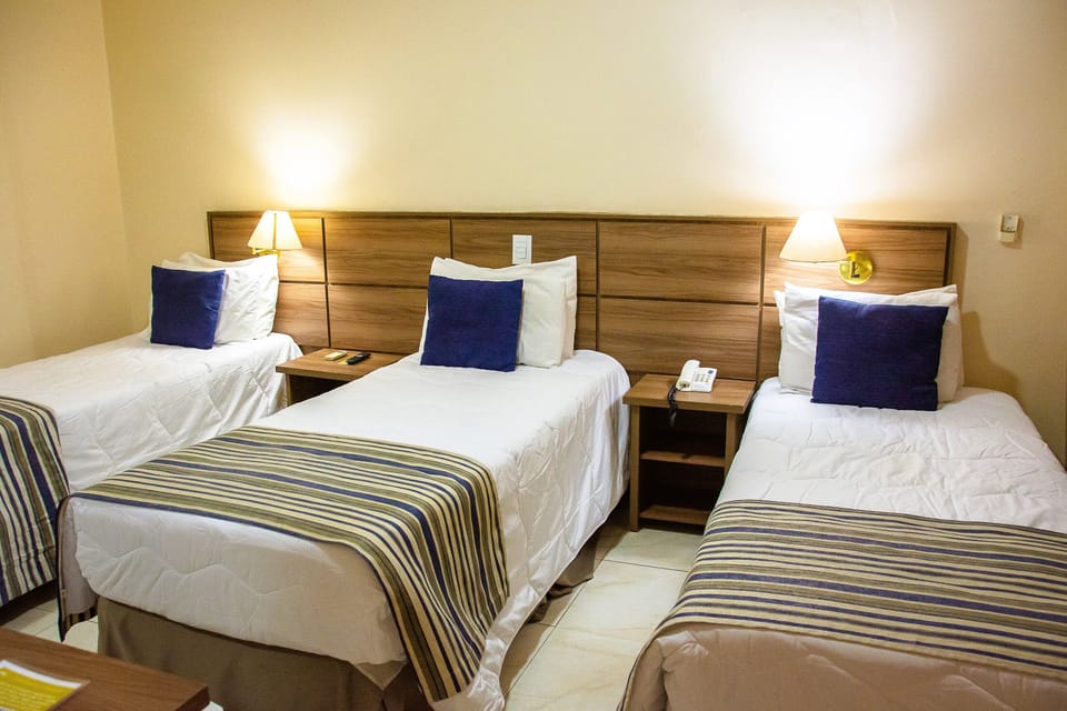 Standard Triple Room | Minibar, in-room safe, desk, laptop workspace