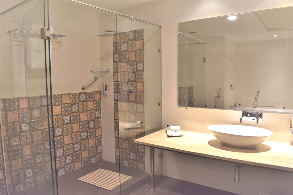 Bathtub, designer toiletries, hair dryer, towels
