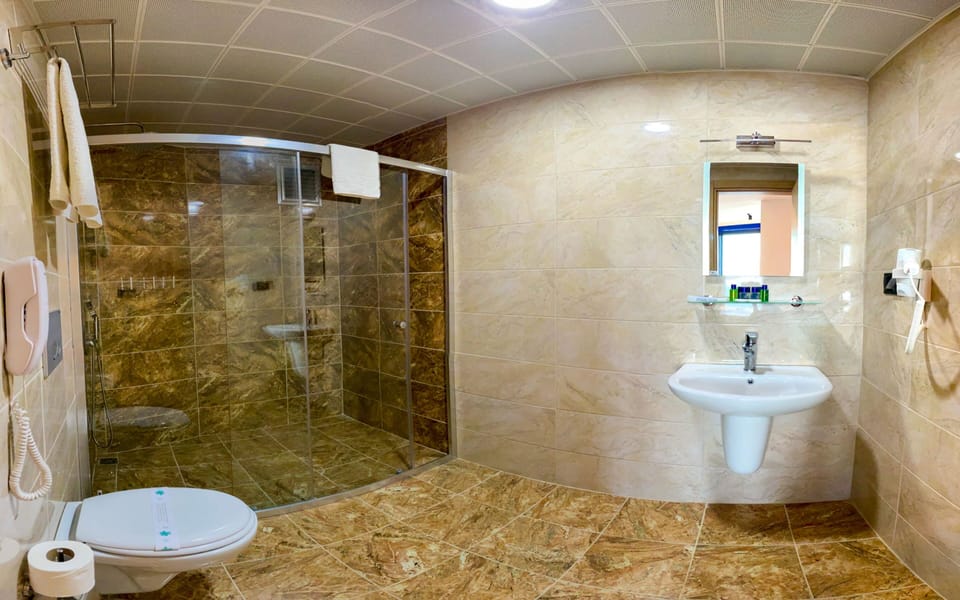 Shower, hair dryer, slippers, towels