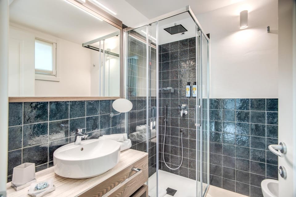 Shower, rainfall showerhead, designer toiletries, hair dryer