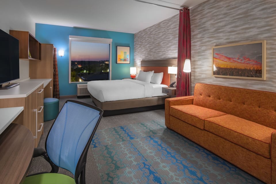 Hypo-allergenic bedding, desk, laptop workspace, blackout drapes