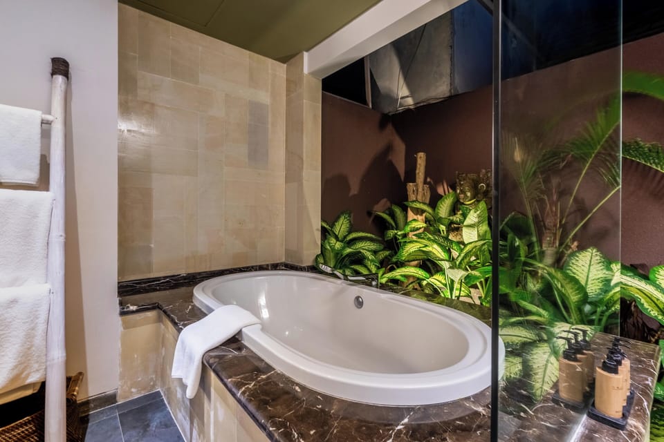 Signature Suites - Adult Only | Bathroom | Shower, free toiletries, bathrobes, slippers