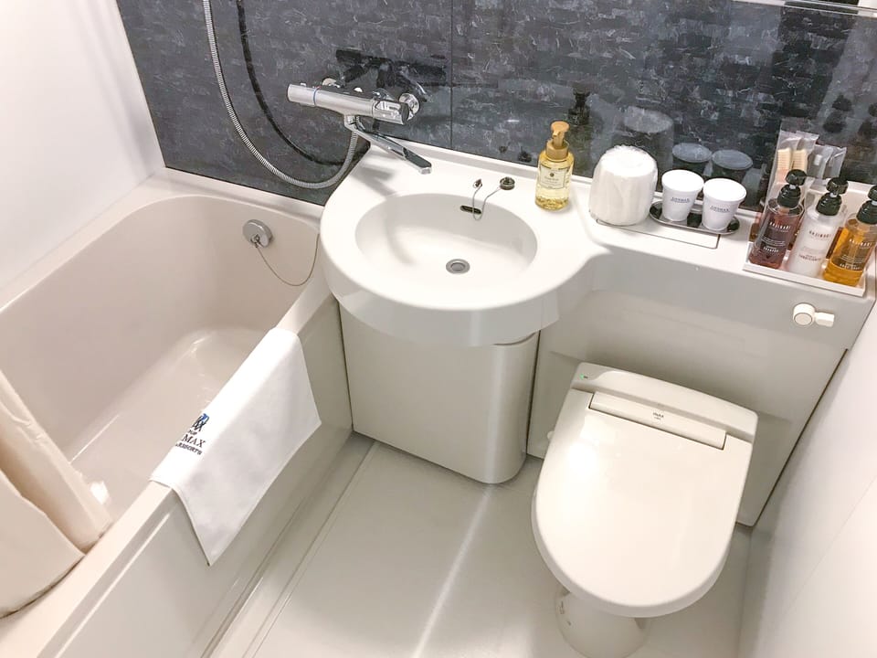 Combined shower/tub, free toiletries, hair dryer, slippers