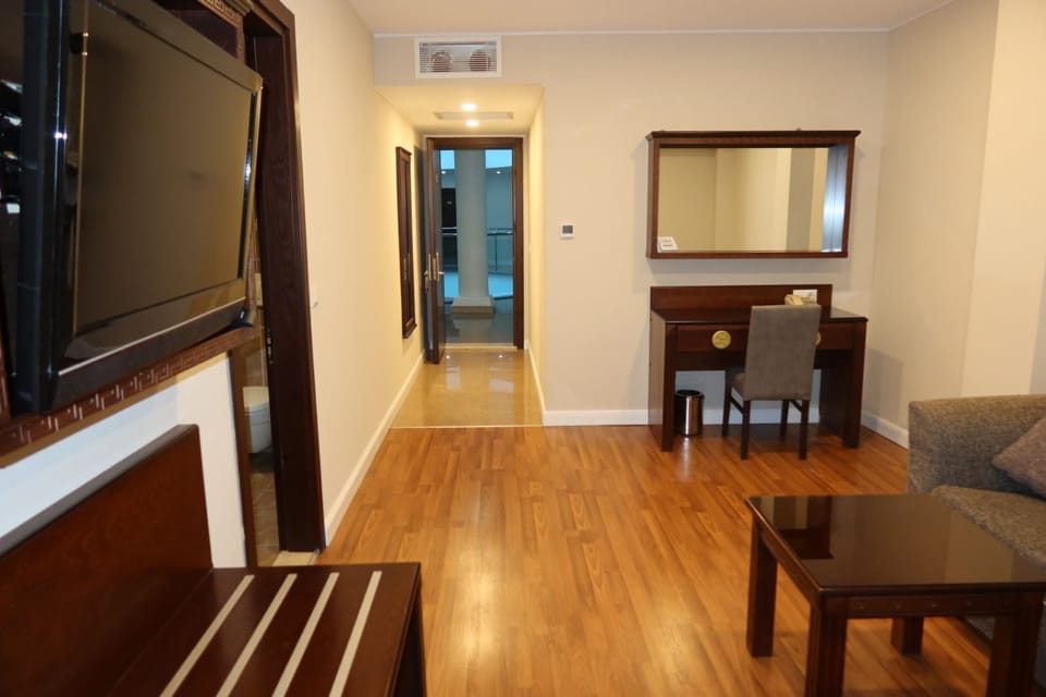 Junior Suite | Living area | 56-inch Smart TV with cable channels, TV