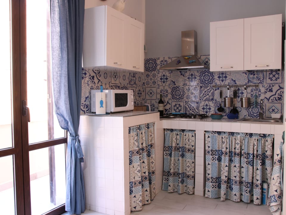 Deluxe Apartment | Private kitchen | Full-size fridge, coffee/tea maker, cookware/dishes/utensils