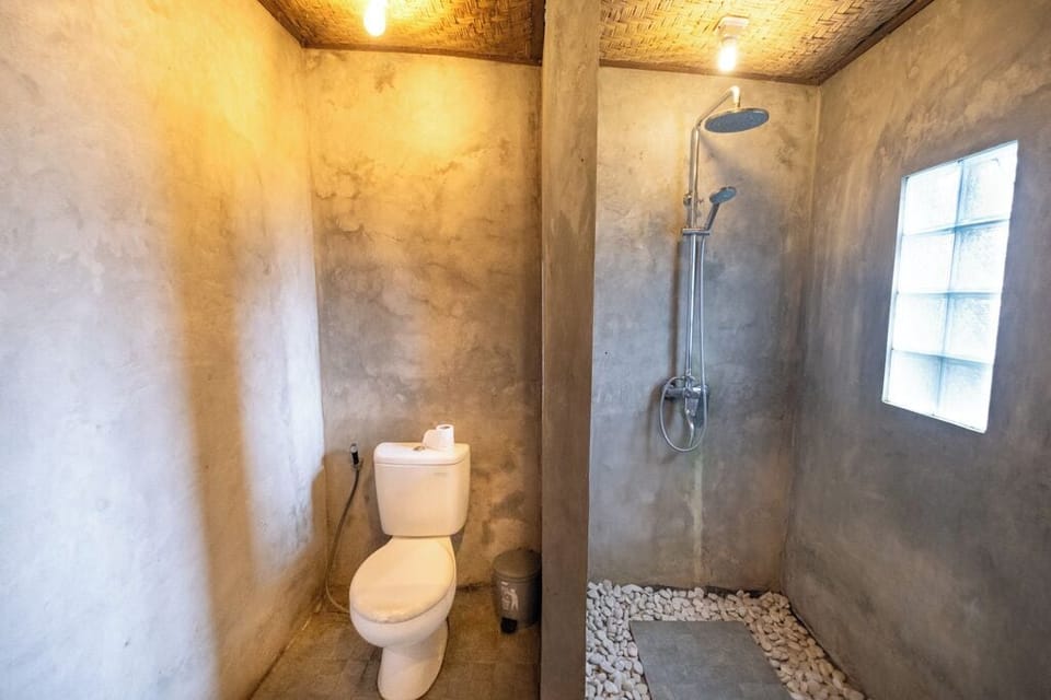 Family Joglo | Bathroom | Shower, rainfall showerhead, towels, soap