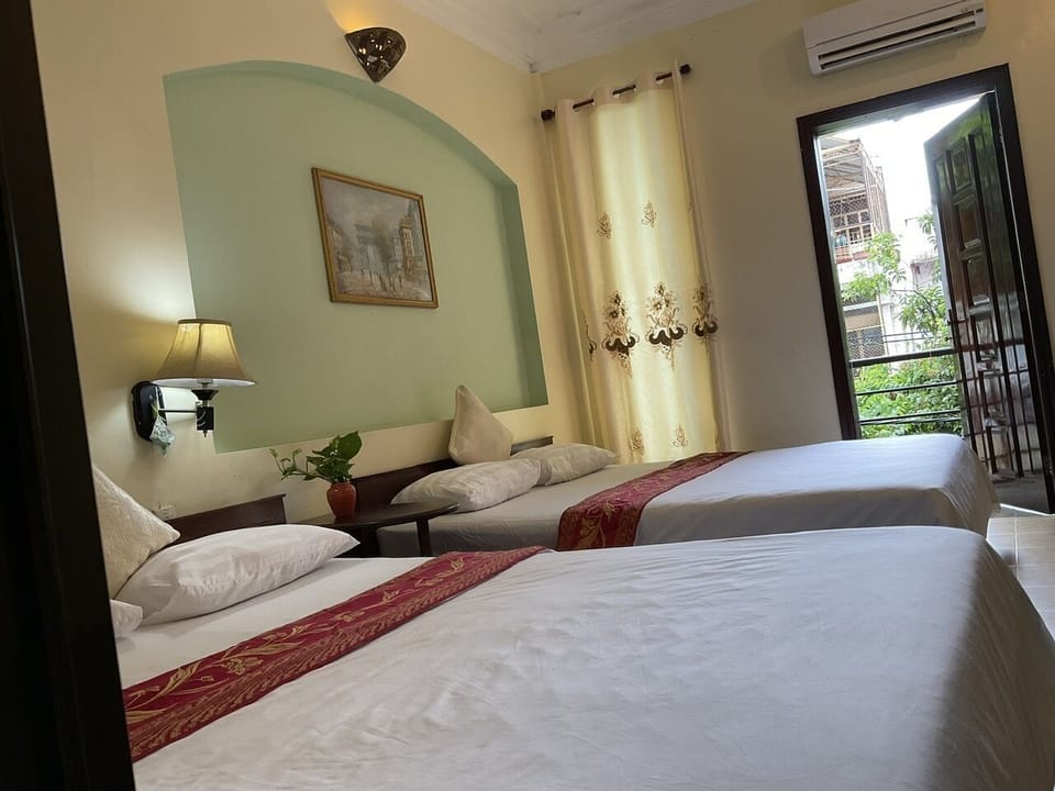 Deluxe Room, 2 Queen Beds | Living area | 21-inch TV with cable channels