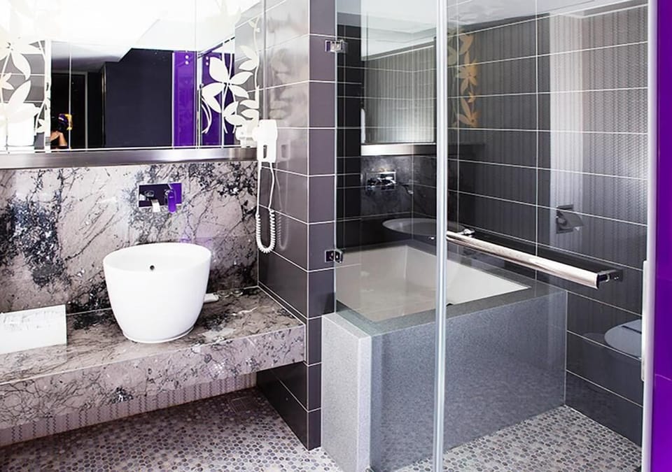 Separate tub and shower, hair dryer, slippers, towels