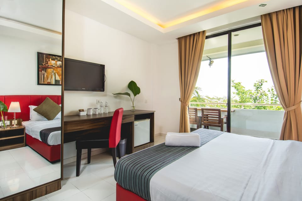 Deluxe King Partial Sea View | Minibar, desk, laptop workspace, free WiFi
