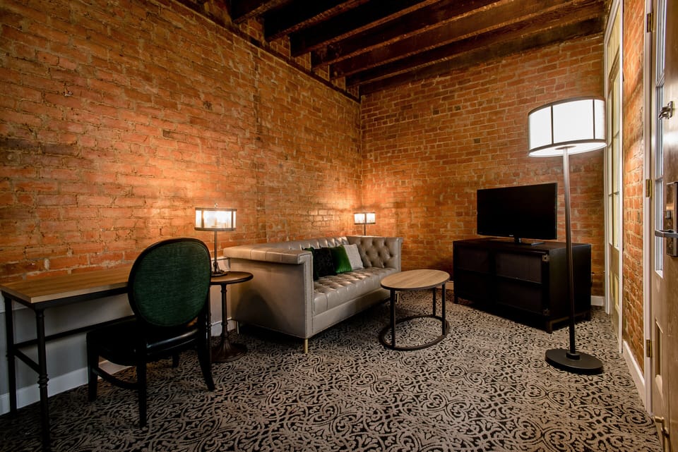 Suite, 1 King Bed, Courtyard View | In-room safe, desk, laptop workspace, blackout drapes