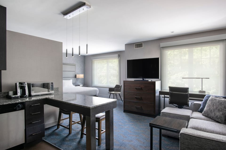 Premium bedding, desk, laptop workspace, blackout drapes