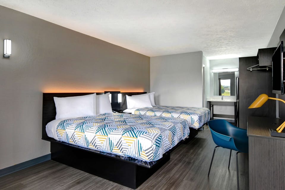 Premium bedding, desk, laptop workspace, blackout drapes