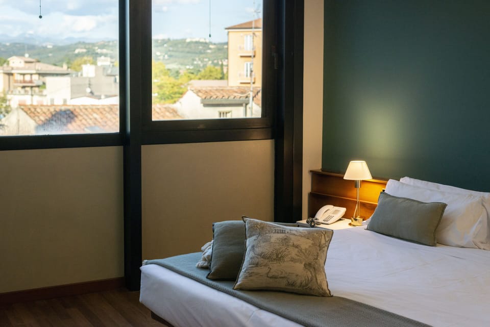 Economy Double Room | Minibar, in-room safe, desk, blackout drapes