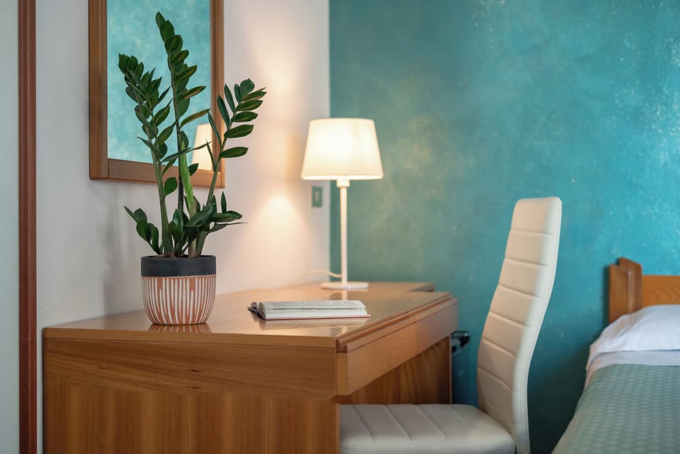 Family Quadruple Room, Balcony, Garden View | Minibar, in-room safe, desk, laptop workspace