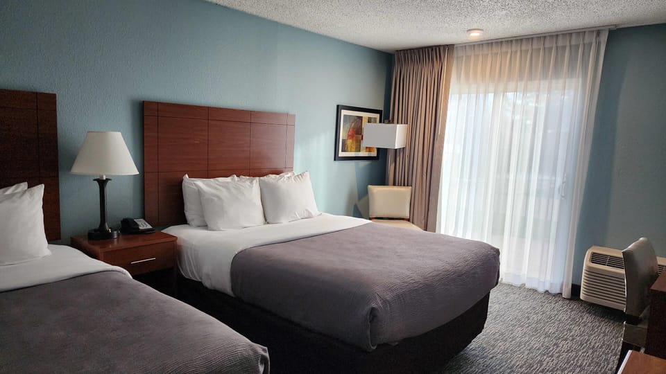 Suite, Multiple Beds, Non Smoking | Desk, laptop workspace, blackout drapes, iron/ironing board