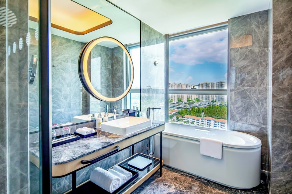 Separate tub and shower, rainfall showerhead, designer toiletries