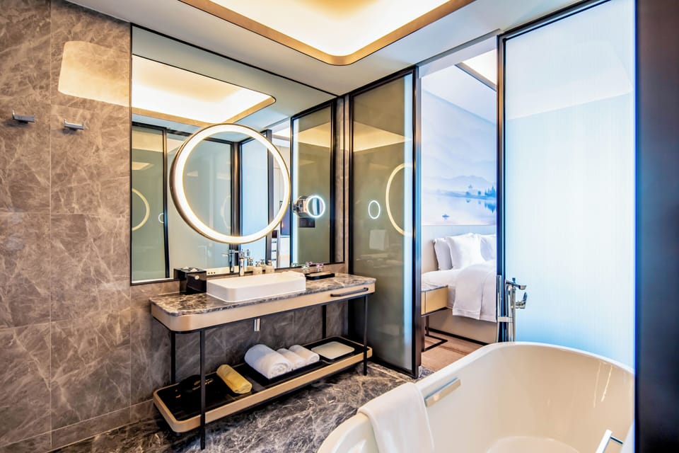 Separate tub and shower, rainfall showerhead, designer toiletries