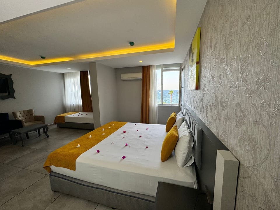 Twin Room, Multiple Beds, Smoking, Partial Sea View | Free WiFi, bed sheets