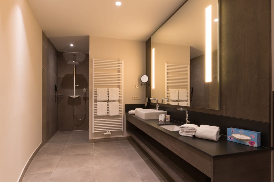Penthouse | Bathroom | Rainfall showerhead, hair dryer, bathrobes, slippers