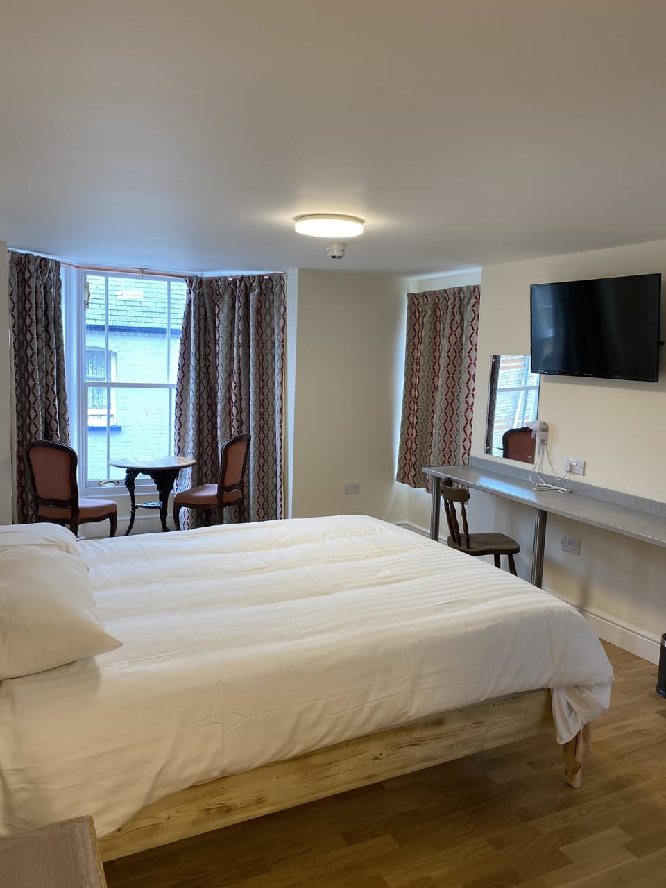 Desk, iron/ironing board, bed sheets