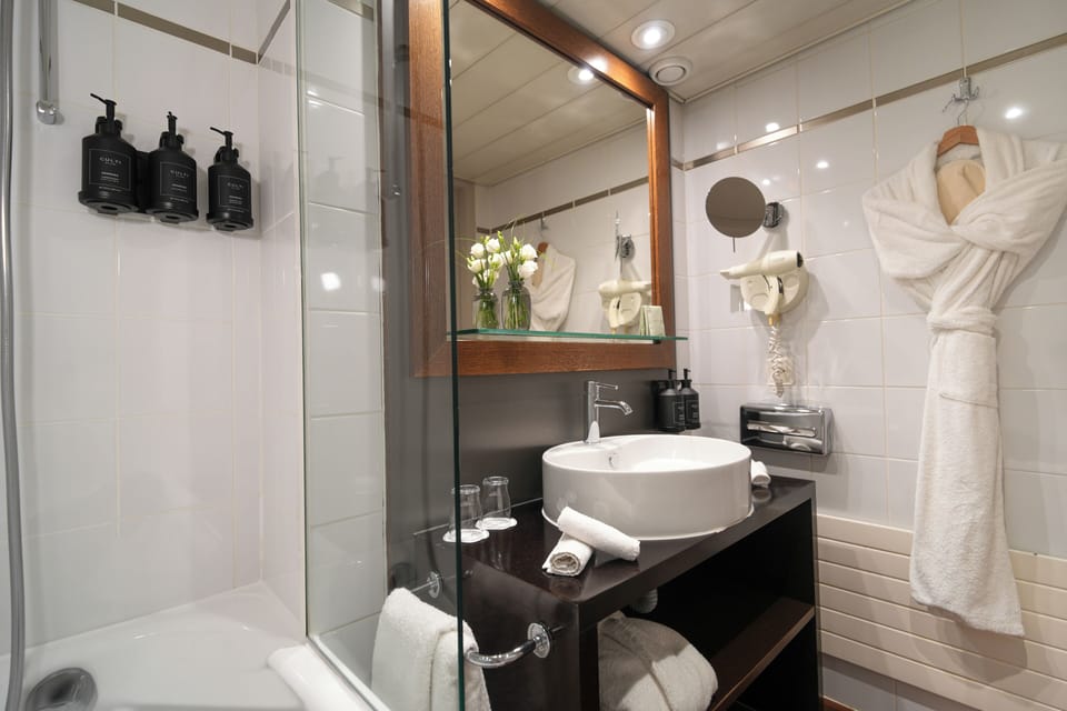 Bathtub, eco-friendly toiletries, hair dryer, towels