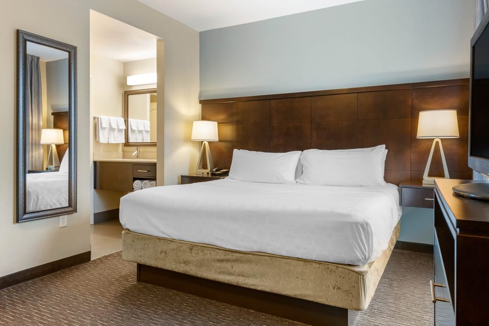 Premium bedding, desk, laptop workspace, iron/ironing board