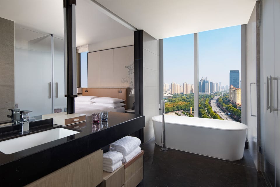 Deluxe Suite, 1 Bedroom, Smoking | Bathroom | Rainfall showerhead, free toiletries, hair dryer, bathrobes