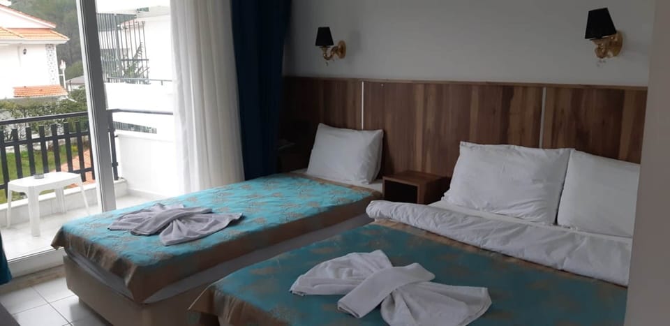 Family Triple Room | Minibar, in-room safe, WiFi (free), bed sheets