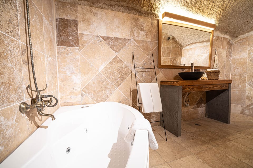 Traditional Suite, Jetted Tub | Bathroom | Free toiletries, hair dryer, slippers, towels
