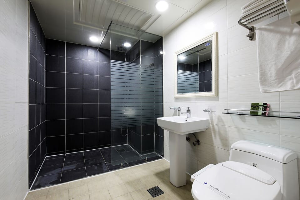 Shower, designer toiletries, hair dryer, bathrobes